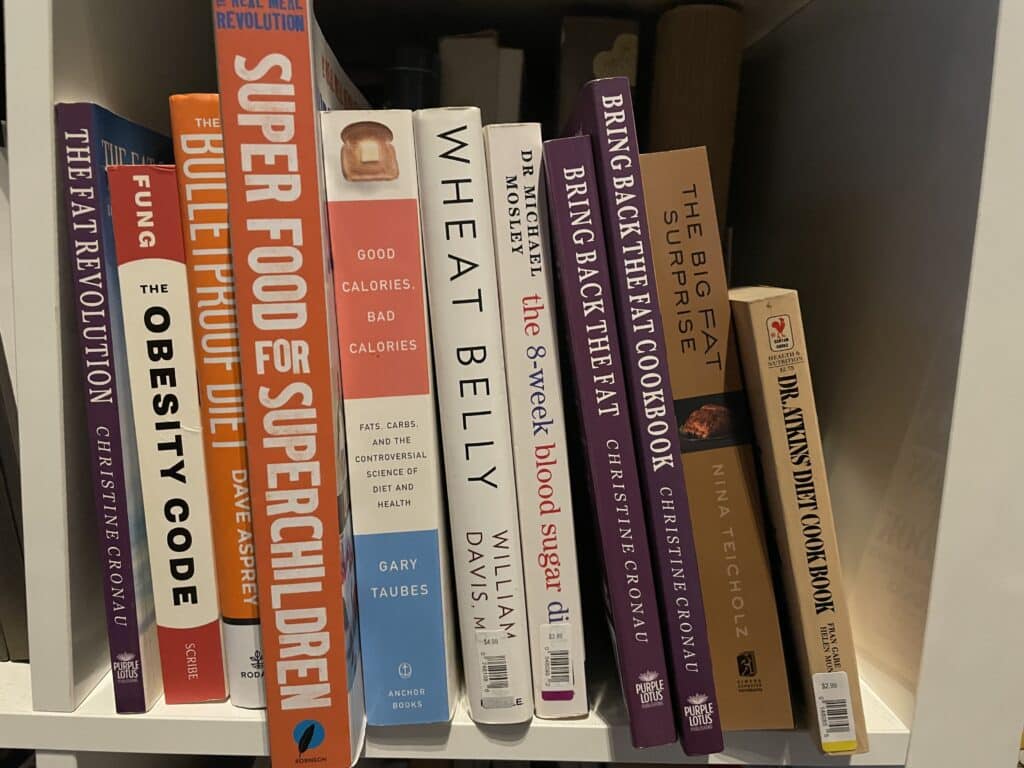 Weight loss and nutrition books inside of book shelf.