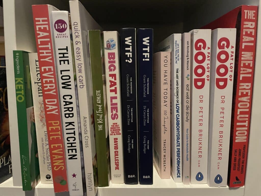 Weight loss and nutrition books inside of book shelf.