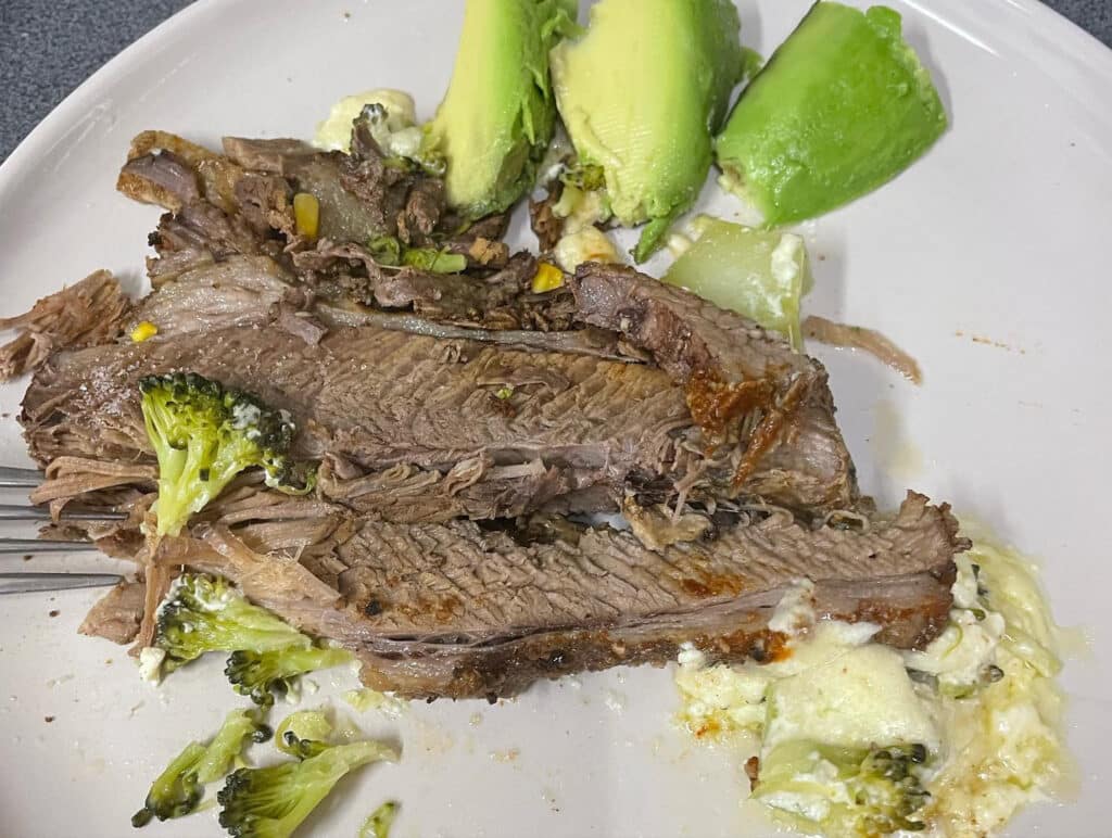 Beef brisket, 3 avocadoes, broccoli, cauliflower, and cheese on plate.