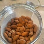 Almonds in glass container.