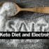 Wooden spoon filled up with salt on table with a label saying The Keto Diet and Electrolytes next to the spoon.