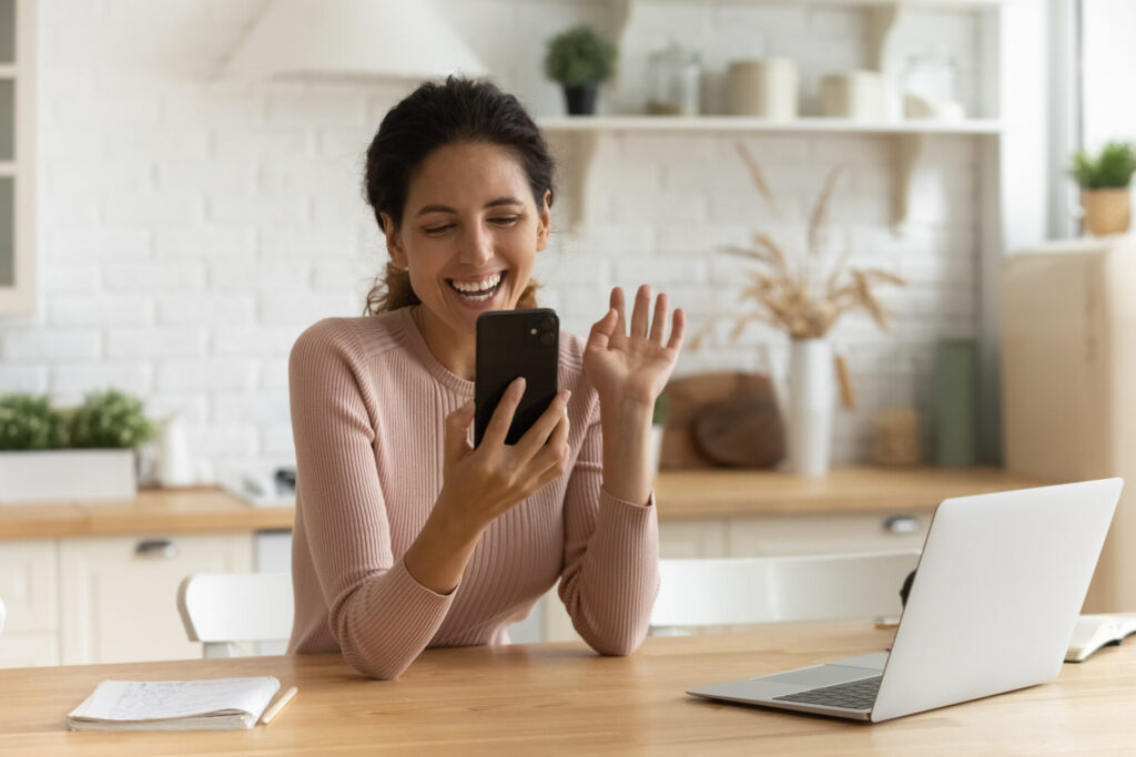 Woman on call with her keto doctor and smiling.