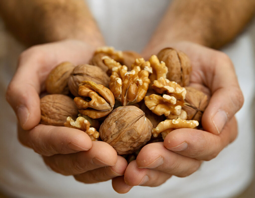 Man holding out Keto Diet nuts in his hands.