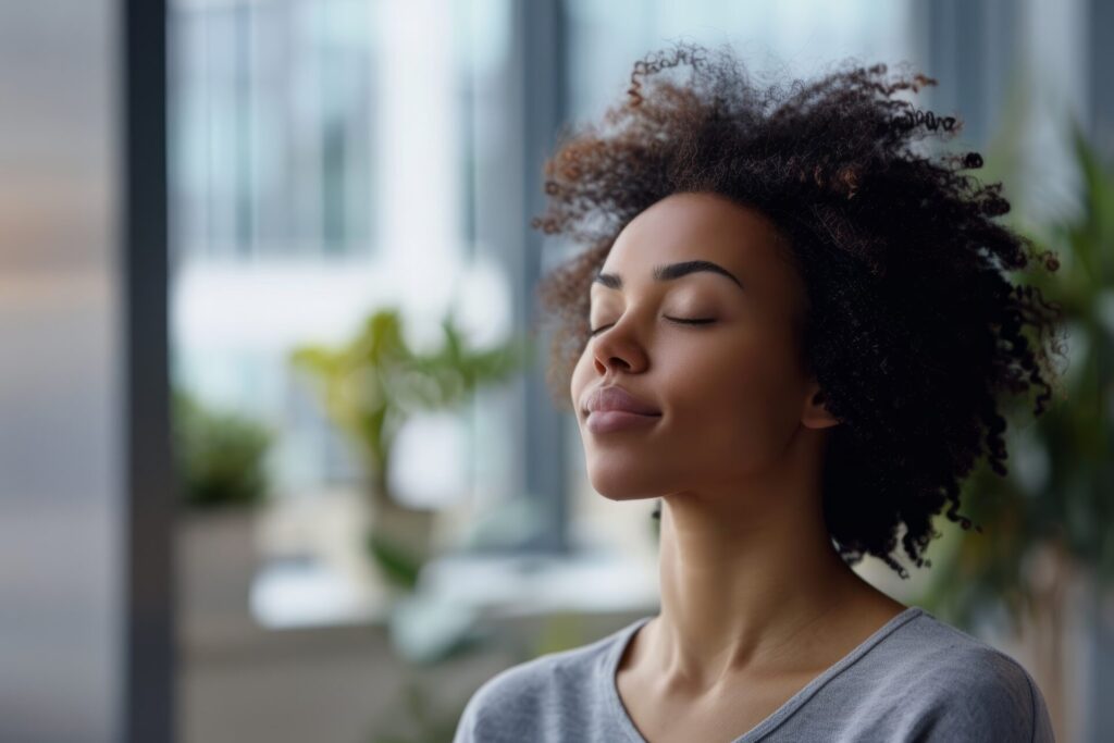 Woman focusing on her breathing at work to calm down.